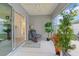 Enclosed sunroom featuring a ceiling fan, neutral flooring, sliding glass doors, plants, and furniture at 5934 Kaplan Ct, The Villages, FL 32163