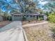 Charming single-story home featuring mature landscaping, a two-car garage, and welcoming curb appeal at 618 N Grandview St, Mount Dora, FL 32757