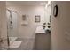 Bright bathroom with a double sink vanity, framed mirrors, a walk-in shower, and modern fixtures at 7133 Sw 135Th Pl, Ocala, FL 34473