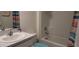 Cozy bathroom featuring a tub with shower, a toilet, and a sink with vanity at 7133 Sw 135Th Pl, Ocala, FL 34473