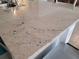 Close-up showcasing the kitchen's elegant granite countertop with natural stone variations and sleek design at 7133 Sw 135Th Pl, Ocala, FL 34473