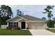Charming one-story home with a well-manicured lawn and a neutral-colored exterior at 7133 Sw 135Th Pl, Ocala, FL 34473