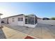 Backyard patio with a fully screened-in porch, with a view to the blue sky at 731 Hernandez Dr, The Villages, FL 32159