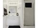 Well-lit bathroom featuring a vanity with storage, mirror, and a glass-enclosed shower at 731 Hernandez Dr, The Villages, FL 32159