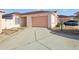 Exterior view of home showing a two-car garage and a well-maintained driveway at 731 Hernandez Dr, The Villages, FL 32159