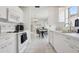 Open-concept kitchen with white appliances and cabinetry and seamless transition to the dining area at 731 Hernandez Dr, The Villages, FL 32159
