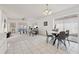 Spacious living and dining area featuring tile floors, modern furniture, and sliding glass doors to the outdoors at 731 Hernandez Dr, The Villages, FL 32159