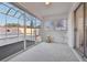 Bright sunroom with sliding glass doors, carpeted floor, and a ceiling fan at 731 Hernandez Dr, The Villages, FL 32159