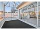 Screened-in sunroom with glass doors leading to indoor and outdoor spaces at 731 Hernandez Dr, The Villages, FL 32159