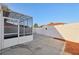 Spacious concrete patio with a lanai featuring a geometric glass ceiling and neutral exterior paint at 731 Hernandez Dr, The Villages, FL 32159