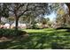 Expansive green space with mature trees and manicured landscaping at 731 Hernandez Dr, The Villages, FL 32159