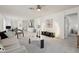 Bright and airy living room with modern decor, ceiling fan and neutral-colored furniture at 731 Hernandez Dr, The Villages, FL 32159