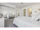 Bright main bedroom featuring a mirrored closet, plush carpeting, and an ensuite bathroom at 731 Hernandez Dr, The Villages, FL 32159