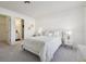 Cozy main bedroom featuring neutral tones, soft carpet, and ensuite bathroom access at 731 Hernandez Dr, The Villages, FL 32159