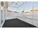 Enclosed lanai with a geometric ceiling and black carpet, offers privacy and outdoor living space at 731 Hernandez Dr, The Villages, FL 32159