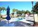 Beautiful community pool with lounge chairs and lush landscaping at 731 Hernandez Dr, The Villages, FL 32159