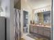 Well-lit bathroom features a double vanity, large mirror, and a separate toilet and shower area at 737 Bolivar St, The Villages, FL 32159