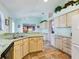 Cozy kitchen features light cabinets, tile flooring, and breakfast bar at 737 Bolivar St, The Villages, FL 32159