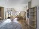 Open-concept living and dining area with hardwood floors, ample natural light, and elegant chandelier at 737 Bolivar St, The Villages, FL 32159