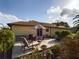 Spacious patio with outdoor seating, an umbrella, and a lush, green yard at 737 Bolivar St, The Villages, FL 32159