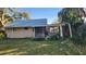 Exterior backyard view with a screen porch and partially fenced yard at 815 E 11Th Ave, Mount Dora, FL 32757