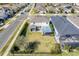 Aerial view of a well-maintained home with a spacious backyard, patio, and surrounding greenery at 831 Zeek Ridge Ct, Clermont, FL 34715