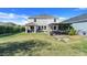 Expansive backyard with a covered patio, grilling area, and meticulously maintained lawn at 831 Zeek Ridge Ct, Clermont, FL 34715