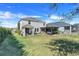 A spacious backyard with a pergola and covered patio, perfect for outdoor entertaining and relaxing at 831 Zeek Ridge Ct, Clermont, FL 34715