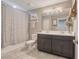 Neutral bathroom featuring a double sink vanity with dark cabinets and a tile floor at 831 Zeek Ridge Ct, Clermont, FL 34715