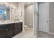 Bathroom with dual sinks, dark cabinets, neutral paint and tile and a separate WC at 831 Zeek Ridge Ct, Clermont, FL 34715