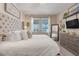 Bright bedroom featuring soft decor and a neutral color scheme with a king bed and ample natural light at 831 Zeek Ridge Ct, Clermont, FL 34715
