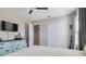 Neutral toned bedroom with ceiling fan, mounted television, closet, and adjacent doorway at 831 Zeek Ridge Ct, Clermont, FL 34715