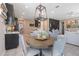 Inviting dining area with stylish chandelier lighting, adjacent to the kitchen and living area at 831 Zeek Ridge Ct, Clermont, FL 34715