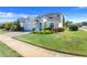 Beautiful two-story home featuring manicured landscaping, a paved driveway, and a welcoming entrance at 831 Zeek Ridge Ct, Clermont, FL 34715