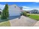 Charming two-story home with a paved driveway, well-manicured lawn, and lush landscaping at 831 Zeek Ridge Ct, Clermont, FL 34715