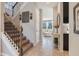 Bright foyer with staircase, decorative accents, and views into the adjacent living room at 831 Zeek Ridge Ct, Clermont, FL 34715