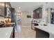 Well-equipped kitchen with stainless steel appliances, dark cabinets, and an open layout at 831 Zeek Ridge Ct, Clermont, FL 34715