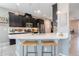 Modern kitchen with dark cabinetry, white countertops, and stainless steel appliances at 831 Zeek Ridge Ct, Clermont, FL 34715