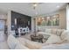 Comfortable living room with feature wall, modern decor, and a large sectional sofa at 831 Zeek Ridge Ct, Clermont, FL 34715