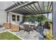 Inviting covered patio features a dining table, seating area, and outdoor bar for relaxing and entertaining at 831 Zeek Ridge Ct, Clermont, FL 34715