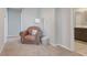 Cozy sitting area showing a tan leather chair with side table and view into a modern bathroom at 831 Zeek Ridge Ct, Clermont, FL 34715