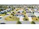 A sprawling aerial view of a peaceful neighborhood showcasing mature landscaping and well-maintained homes at 909 Abaco Path, The Villages, FL 32163