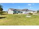Well-kept home featuring a lush green lawn and classic architecture under a bright blue sky at 909 Abaco Path, The Villages, FL 32163