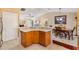 Bright kitchen with counter seating area open to the dining room and featuring light countertops at 909 Abaco Path, The Villages, FL 32163