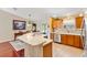 Kitchen with stainless steel appliances, light countertops, and eat-in dining area at 909 Abaco Path, The Villages, FL 32163