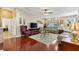 Bright living room with hardwood floors, neutral walls, and a large window providing natural light at 909 Abaco Path, The Villages, FL 32163