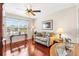 Cozy living room with large window and hardwood floors at 909 Abaco Path, The Villages, FL 32163
