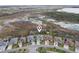 A peaceful residential street borders a flourishing wetland area, highlighted with an overlaid location pin at 960 Pickering Path, The Villages, FL 32163