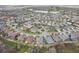 Expansive aerial view showcasing the community's layout, featuring well-maintained homes and a picturesque lake and golf course at 960 Pickering Path, The Villages, FL 32163