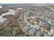 Aerial view of a community with lush landscaping, multiple homes, and retention pond at 960 Pickering Path, The Villages, FL 32163